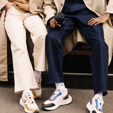 Couple Femme et Homme portant des sneakers orange et bleu et beige et noir de la marque iné, unisexes et disponibles du 36 au 46